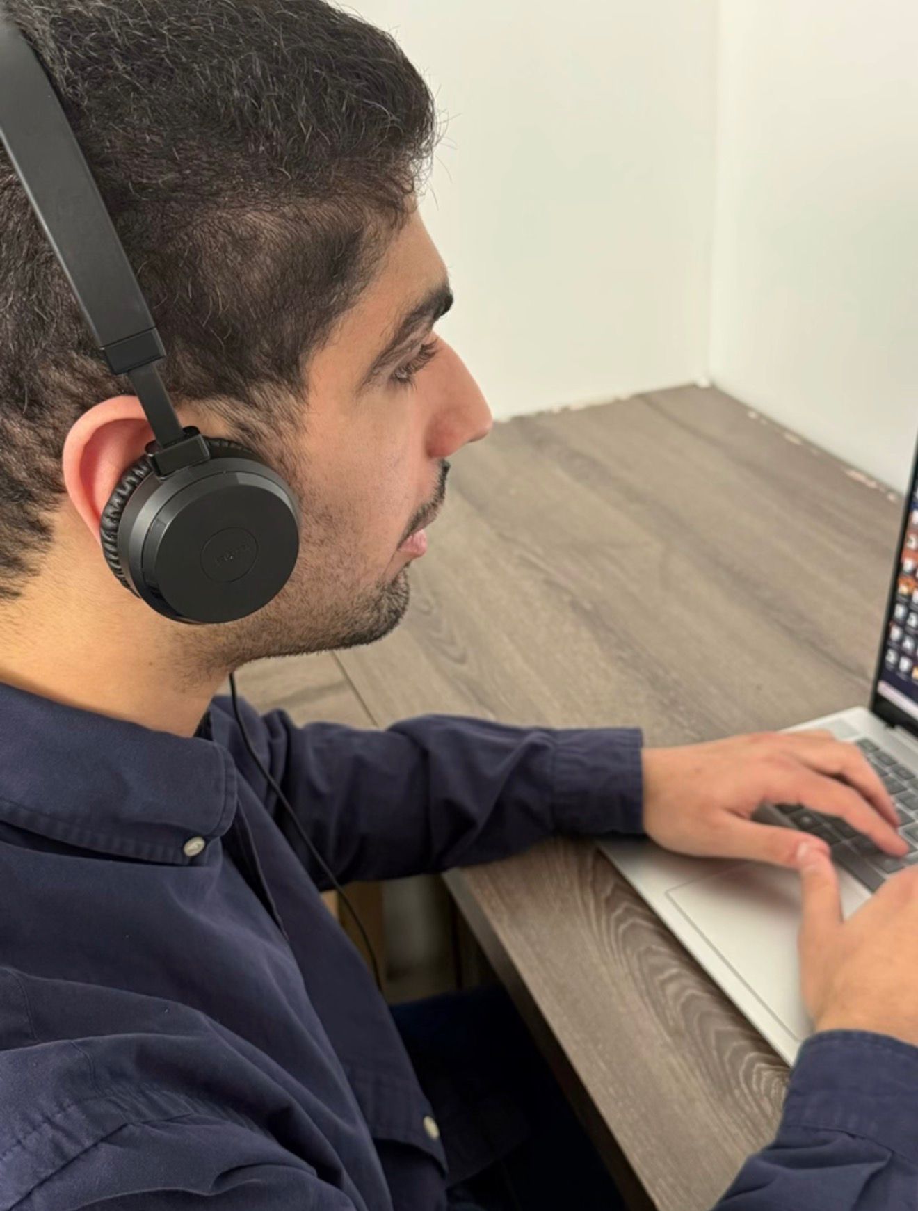 Ahmad Al Jaafeel providing remote interpreting support with professional headset